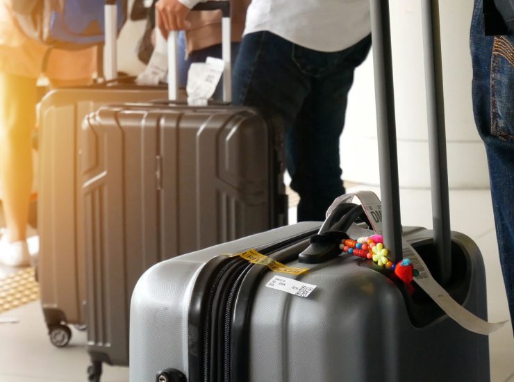 airport taxi. passenger with big roller luggage standing on the line waiting for taxi queue at taxi parking lot at airport arrival terminal